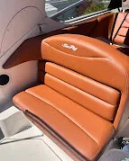 Tan pleated helm seat upholstery with an embroidered logo
